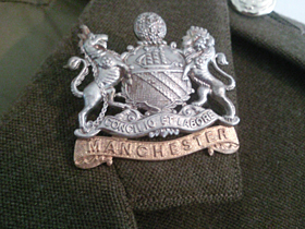 Wilfred's First Manchester Regiment insignia